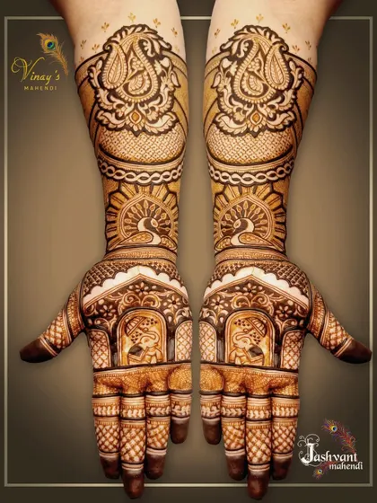 A beautiful symmetrical design for a family member, with elephants in jharokhas on the palms and peacocks on the arms.