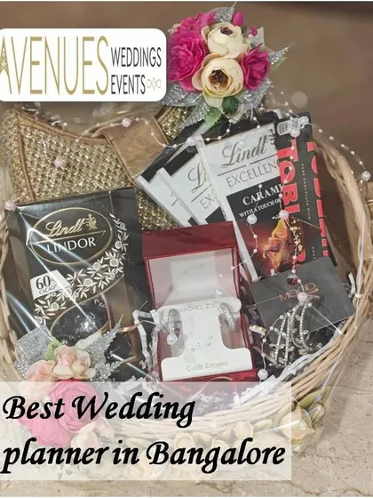 This wicker gift basket combines luxury chocolates with fine jewelry. It's a perfect example of a personalized hamper for a bride, combining her favorite treats with a special gift.
