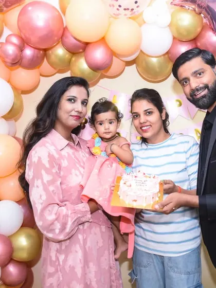 Family and friends join in for a photo, sharing the happiness of the first birthday celebration.