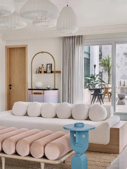 The living room at Eden House, with its playful furniture and view to the outdoor deck, is a perfect example of our whimsical yet balanced design approach.