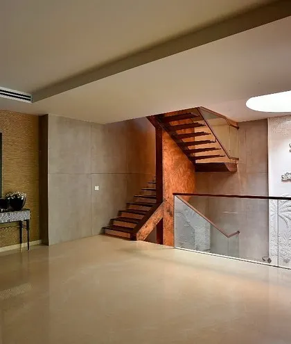 The staircase landing is designed as a clean, open space, allowing the sculptural form of the stairs and the detailed art panel to be the heroes.