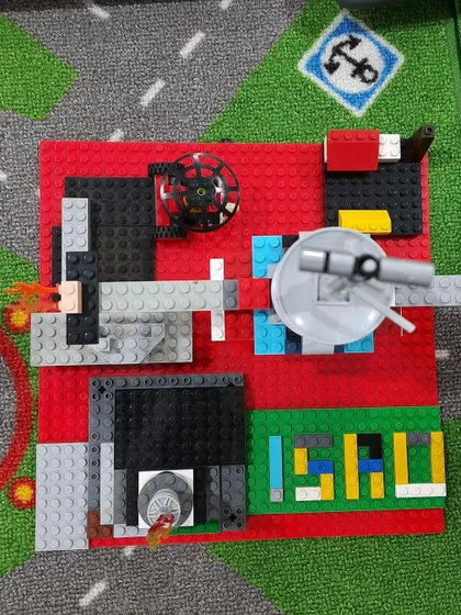 A close-up look at a creative LEGO build. This piece uses various elements to create a dynamic scene, showcasing the problem-solving and artistic skills kids develop.