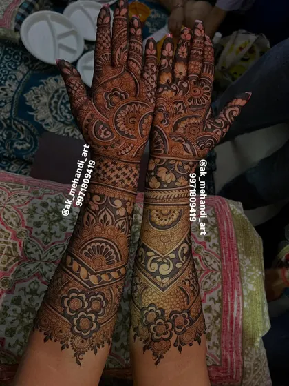 A full view of another intricate bridal design, with different patterns on each arm for a unique look.