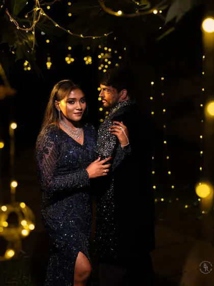 A stylish and moody portrait of the couple surrounded by fairy lights, perfect for a reception or Sangeet.