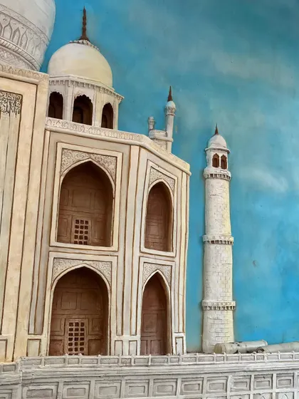 A close-up that highlights the carved windows and patterns on the facade of the Taj Mahal mural, demonstrating the precision of the work.