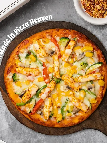 A delicious close-up of our Paneer Pizza, topped with generous chunks of marinated paneer, colorful bell peppers, sweet corn, and gooey mozzarella cheese on a perfectly baked crust.