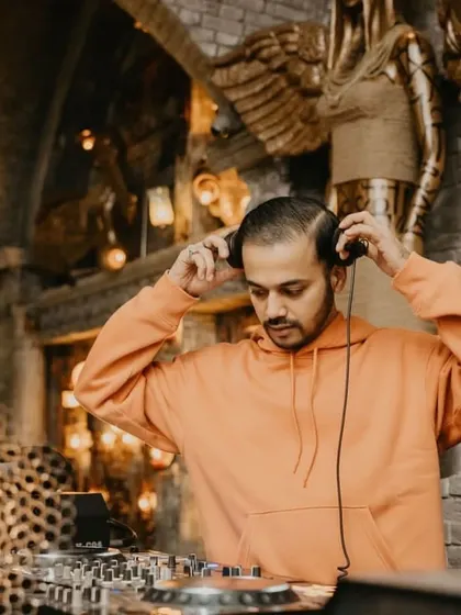 Getting my headphones ready for a Halloween set. The club's gothic decor adds to the spooky vibe.
