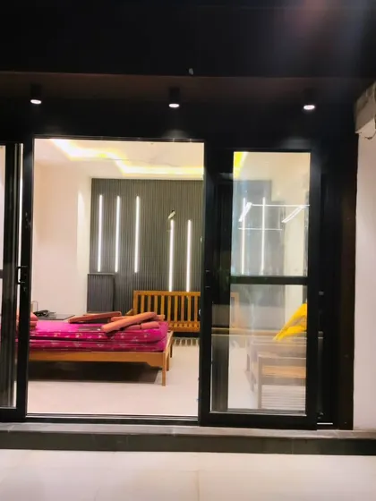 The interior of the Palam Vihar terrace room at night, showing the bedroom setup.