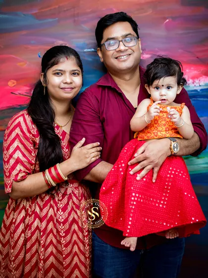 A vibrant family portrait set against a colorful, artistic painted backdrop. This is a great option for families looking for something unique and full of energy.