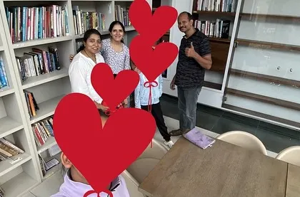 A family posing in the library after a weekend workshop. Combining service learning, like cleaning the library, with educational games creates a holistic and meaningful experience.