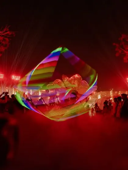 Elevating the night with captivating props. This LED light performance, set against a backdrop of red lights and lasers, created a futuristic and high-energy vibe.