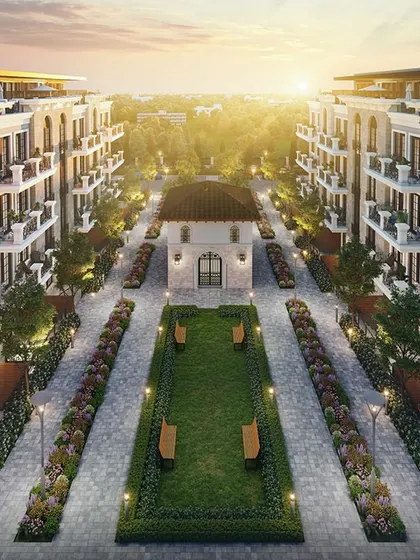 An elevated perspective of the townhouse project at sunset, showing the symmetrical layout of the buildings around a central green courtyard.