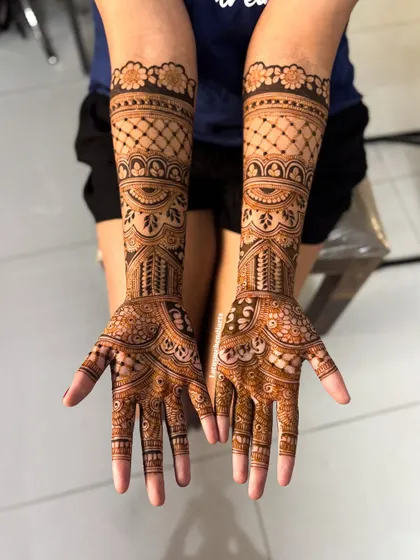 A beautiful, full-coverage design with intricate geometric and floral patterns, perfect for the bride who wants a classic and detailed look.