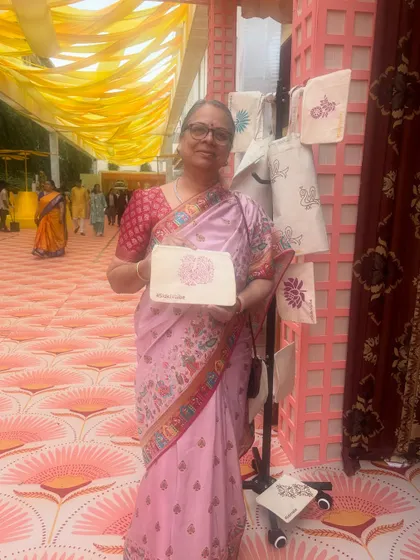 A guest at the Birla and Gokuldas Haldi party proudly displays the pouch she printed. We set up a display of finished examples to inspire everyone and show them what's possible.