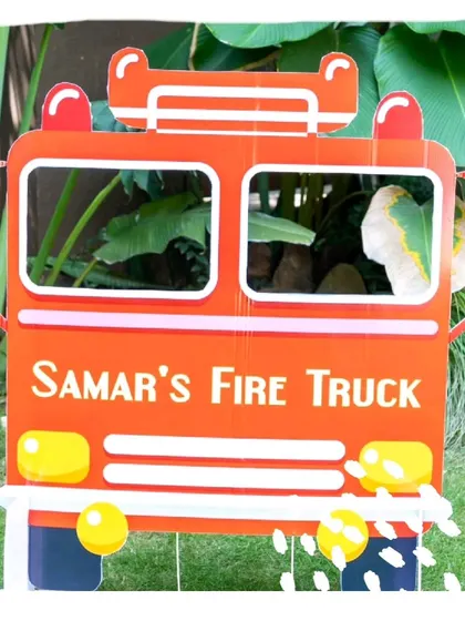 A personalized fire truck photo prop, allowing little guests to pretend they are driving their own emergency vehicle.