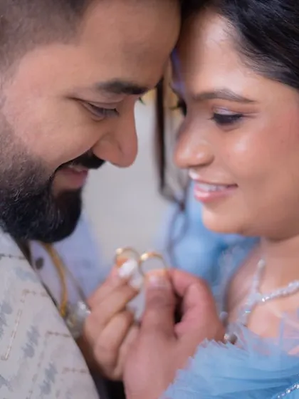 A beautiful close-up of the ring exchange. Her makeup is soft and romantic, perfect for capturing these intimate moments.