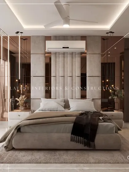 A beautifully composed shot of a master bedroom, featuring a plush upholstered bed, elegant pendant lights, and mirrored panels that enhance the sense of space and light.