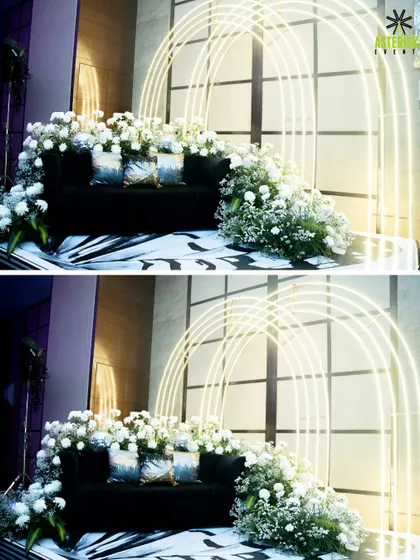 A modern and elegant photo booth for a sangeet and cocktail night. This setup features clean neon arches and lush white florals, providing a chic backdrop for guest photos.