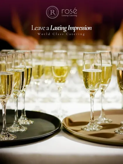 A row of champagne flutes ready for a toast. We help you leave a lasting impression with world-class catering that includes premium beverage service.