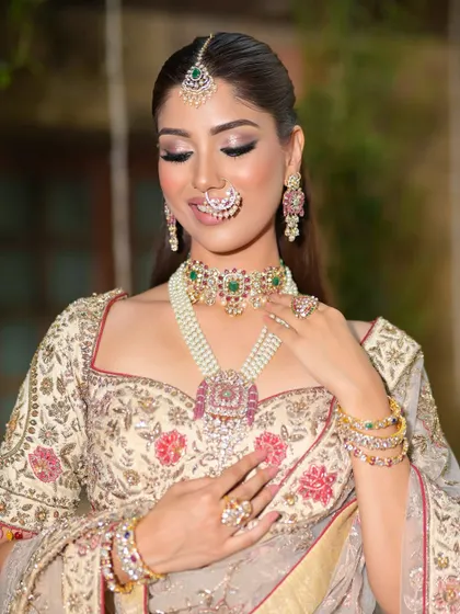 A happy, candid moment. The bride's smile is infectious, and her makeup looks fresh and radiant, even with a dramatic eye.