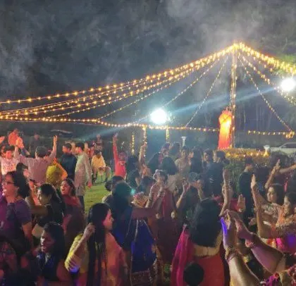 A wide shot of the outdoor Diwali celebration, with everyone dancing.