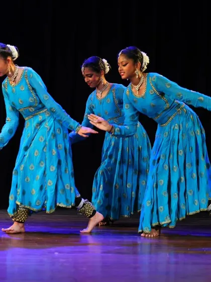 Three of my senior students executing a synchronized movement, highlighting the precision and alignment we practice in our traditional Kathak choreography.