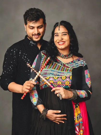 A happy couple celebrating their culture during a maternity shoot. The vibrant Garba attire and joyful smiles make this a truly special portrait.