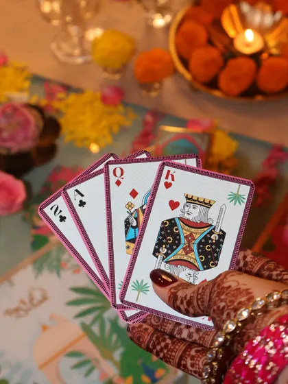 A hand of our custom-designed playing cards, showing the beautiful illustrations and quality. They are perfect for a festive game of Teen Patti with friends and family.