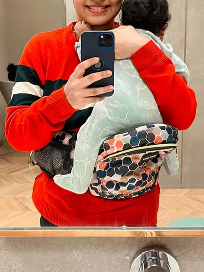 A close-up of the Buttbaby carrier, a product that has been a constant in my parenting journey, helping me keep my baby close.