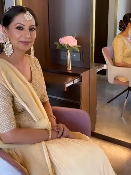 A serene moment in the makeup chair. The final look is elegant and polished, perfect for any festive occasion.