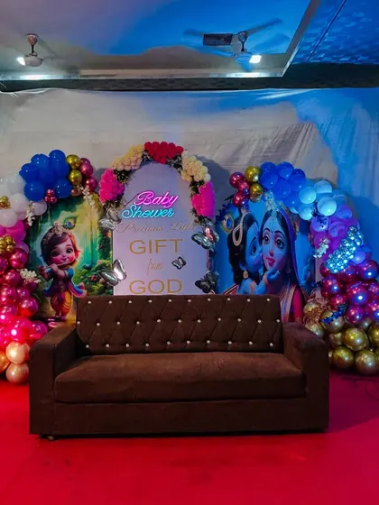 The same premium baby shower setup, shown with the main seating sofa in place. This helps clients visualize how the final stage will look with furniture.