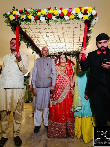 The traditional bridal entry under a Phoolon ki Chadar is a timeless moment. I coordinate with the floral vendor to create a beautiful canopy that complements the bride's attire.