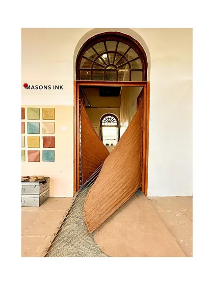 The tensile mud installation at the IAADB, which uses rope and cloth plastered with mud, similar to wattle and daub. The piece creates an inviting entryway for visitors.
