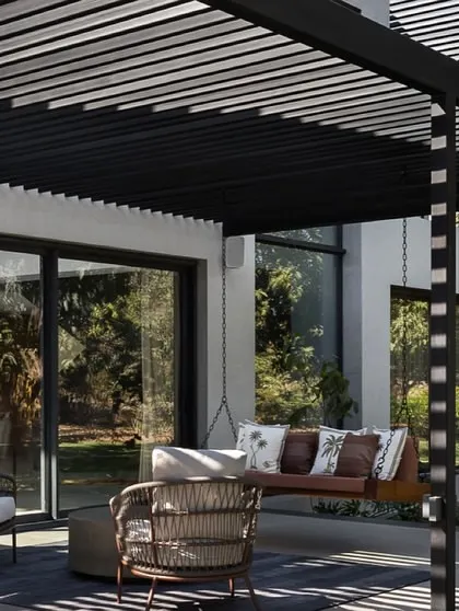 Another view of the outdoor lounge area, highlighting the interplay of light and shadow created by the overhead structure. This space serves as a natural extension of the home's interior living areas.