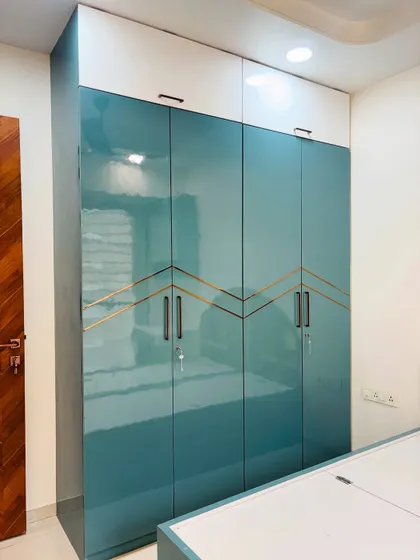 A slightly different angle of the teal wardrobe, showing how the light reflects off the glossy surface.