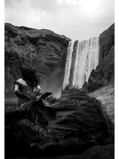 An artistic black and white photo that focuses on the wild, untamed feel of the wind catching Shree's hair and the fabric of her gown.