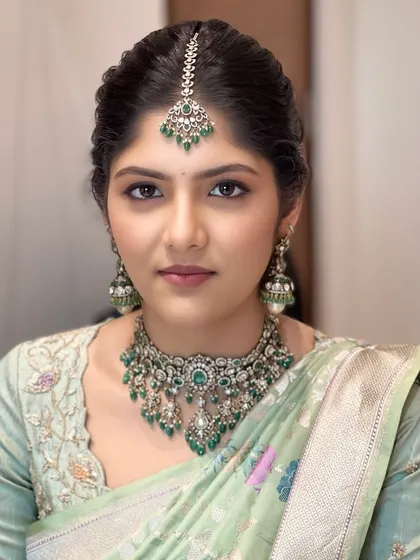 This bride is the picture of elegance in her pastel green saree. The makeup is soft and luminous, a perfect example of the sophisticated, understated glamour I teach.