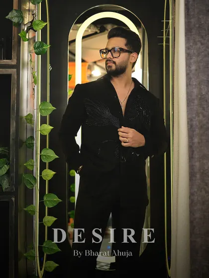 Men in black hits different. This full-length shot of the black-on-black embroidered shirt proves that true style is in the details.