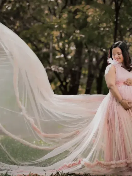 There's something magical about an outdoor maternity shoot. Here, we used the natural beauty of a Bangalore park and a flowing pink gown to create a serene and stunning portrait.