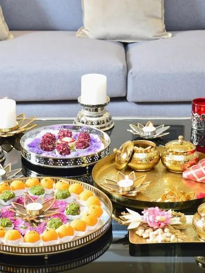A beautiful Lohri gifting spread. Our serveware, including mirror trays and lotus-shaped bowls, is perfect for presenting festive treats and gifts to your loved ones.