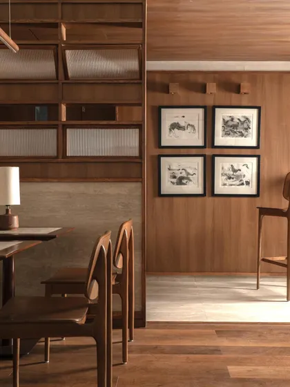 A quiet corner in QBF Coffee, where wood paneling, fluted glass, and curated artwork come together. The design focuses on creating a series of composed vignettes for guests to enjoy.