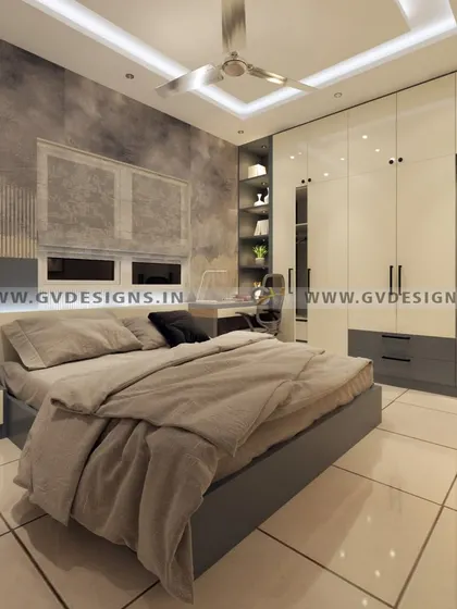 A harmonious blend of grey and white defines this bedroom. We designed a complete wall solution that incorporates a swing wardrobe, a dressing unit with a mirror, and a study desk with open shelving, all unified by a textured wallpaper.