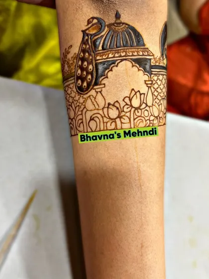 A beautiful cuff design for the arm, featuring a peacock perched on an architectural dome, surrounded by lotus flowers.