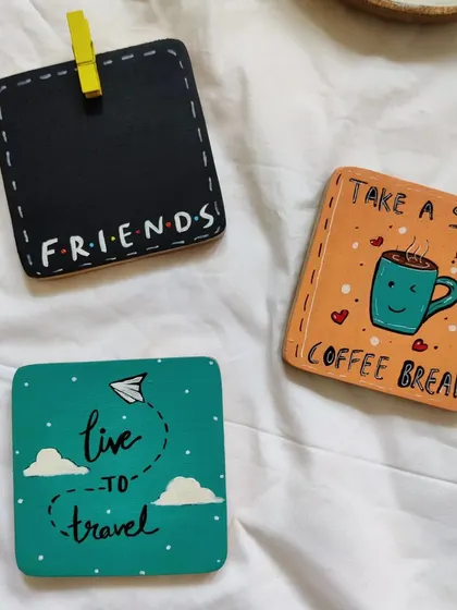 A set of our hand-painted wooden coasters with various themes. From "Friends" to travel and coffee, these make great small gifts or quirky additions to your desk.