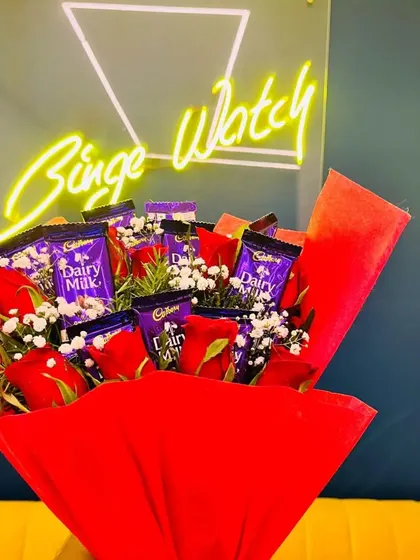 More than just flowers. We can create custom bouquets, like this one featuring red roses and Dairy Milk chocolates, to make your surprise even sweeter.