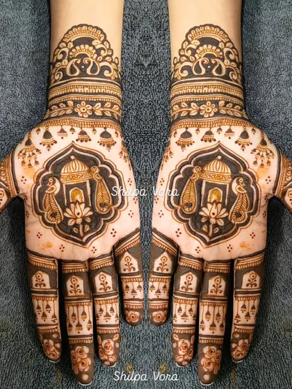 A symmetrical design for Gangour, featuring the sacred 'kalash' (pot) and paisley motifs, symbolizing prosperity and happiness.