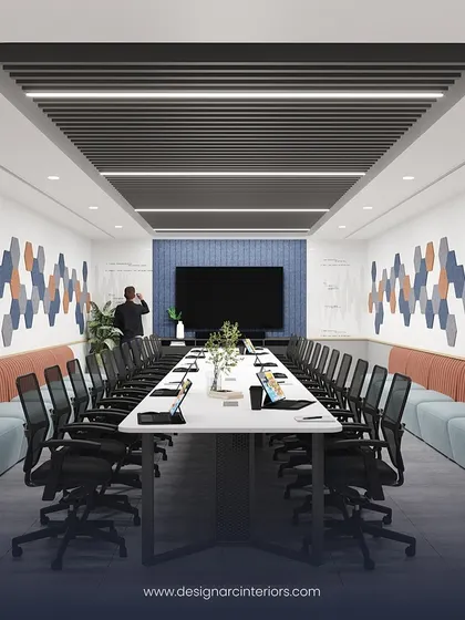 This long conference room is designed for large team meetings. The combination of a long table with supplementary bench seating along the walls maximizes capacity, while the hexagonal acoustic panels add visual interest and reduce echo.