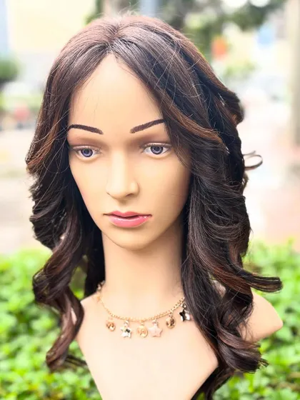 A frontal view of our molten honey customized wig. It features a comfortable cap base and is made with pure Remy hair quality.
