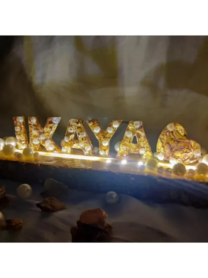 A full view of the LED name stand on a rustic wooden base. This piece combines natural elements with modern lighting to create a truly unique keepsake.