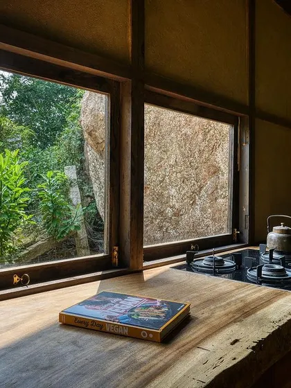 The view from the kitchen counter looks directly out into the green landscape. We believe daily chores can be moments of connection with nature.